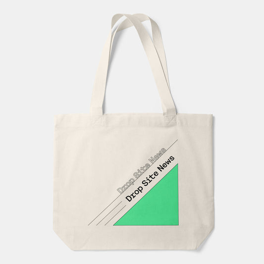 Cream canvas tote bag with long shoulder straps and a green geometric graphic with printed text.